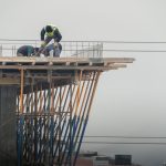 Workers on a high-rise building construction site in Denizli, Türkiye, showcasing teamwork and safety.