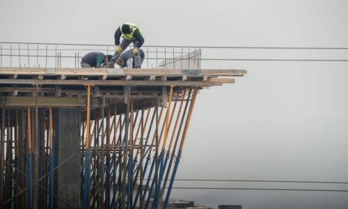 Workers on a high-rise building construction site in Denizli, Türkiye, showcasing teamwork and safety.